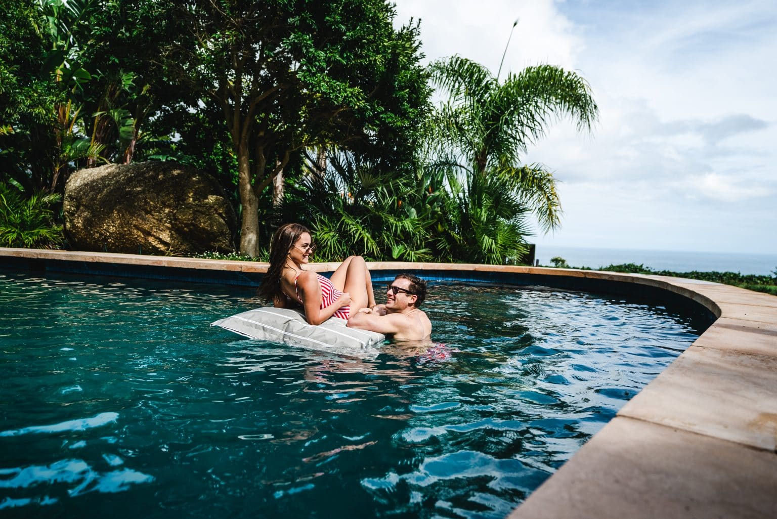 A couple enjoys the pool at 21 Nettleton