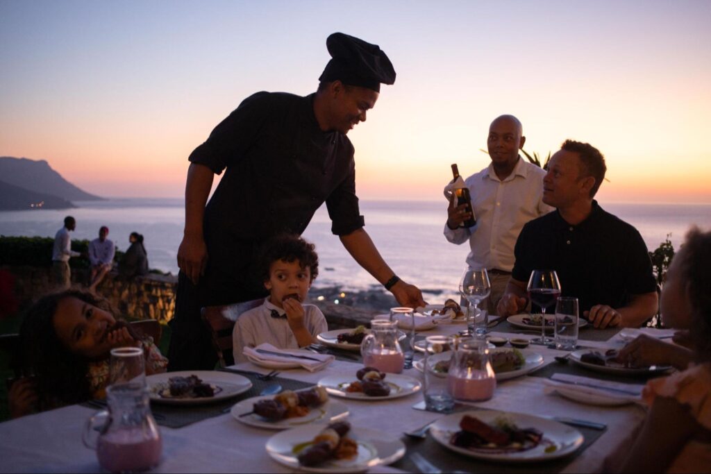 A family enjoying an outdoor dining experience at 21 Nettleton, Cape Town