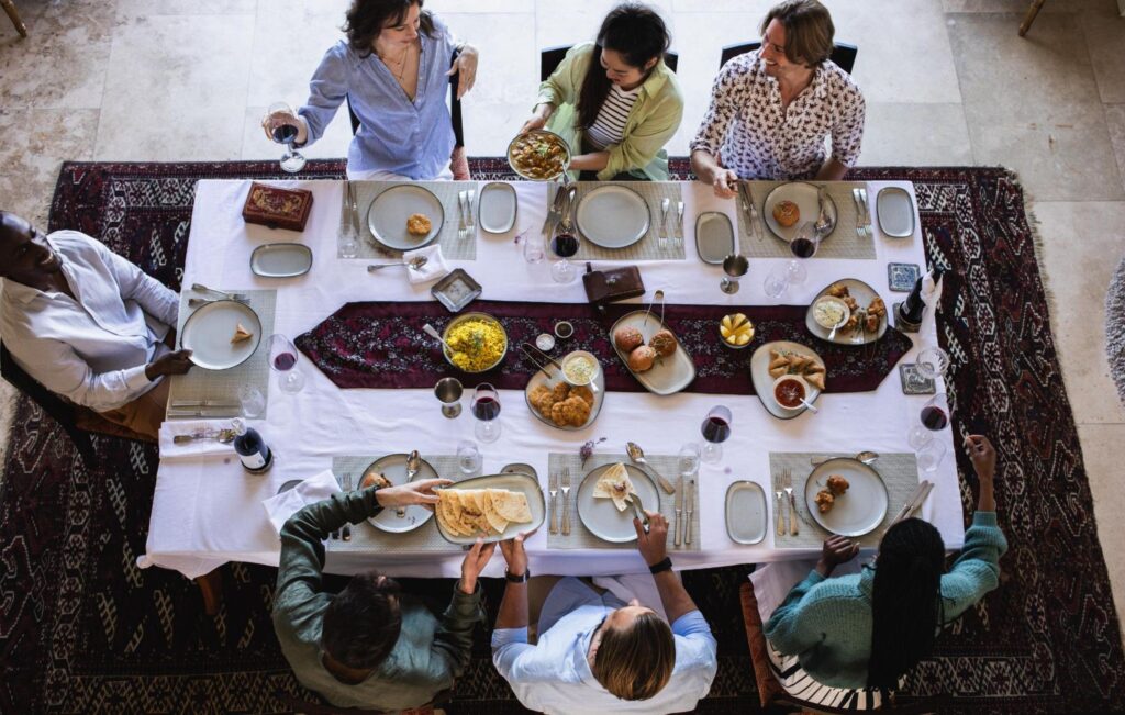 Friends sharing a meal around a table in Cape Town