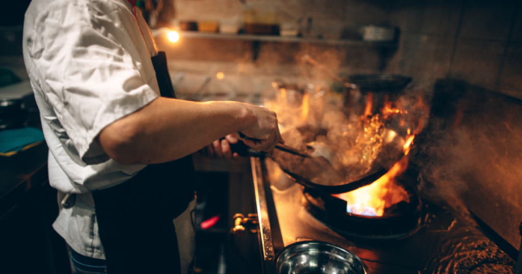 A chef cooking over a fire at a Cape Town restaurant