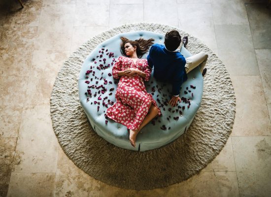 A couple lounges on an ottoman at 21 Nettleton