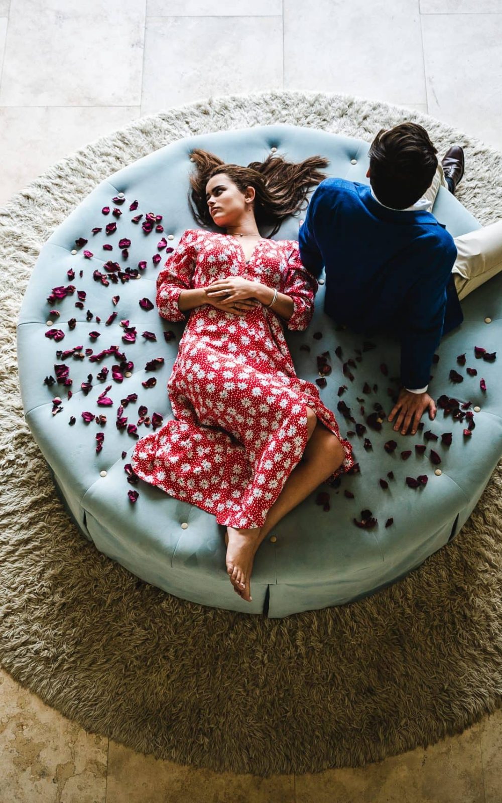 A couple lounges on an ottoman at 21 Nettleton